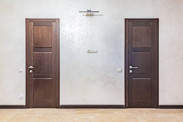 Two doors in the corridor of the luxury rich apartments.