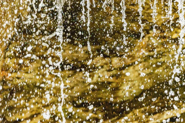 Water drops in the small mountain waterfall.