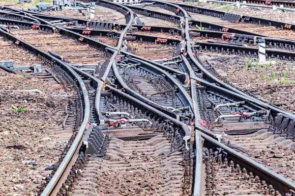 Railway tracks on the big station at day time.