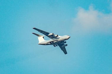 Mavi gökyüzünde ki büyük kargo uçağının uçuşu.