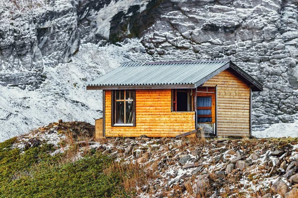 Small wooden house for the climbers on the mountain background. — Stock Photo, Image