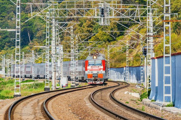 Passenger train moves by Black sea coast.