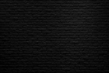 Odanın içinde siyah tuğla duvar arka planı.