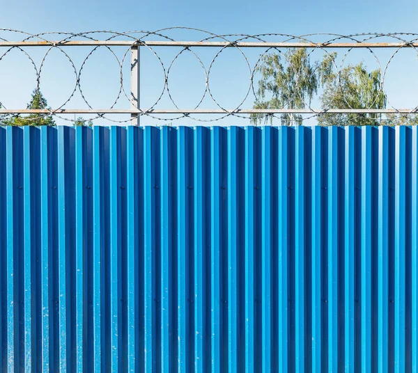 Metal fence with barbed wire in the prison.