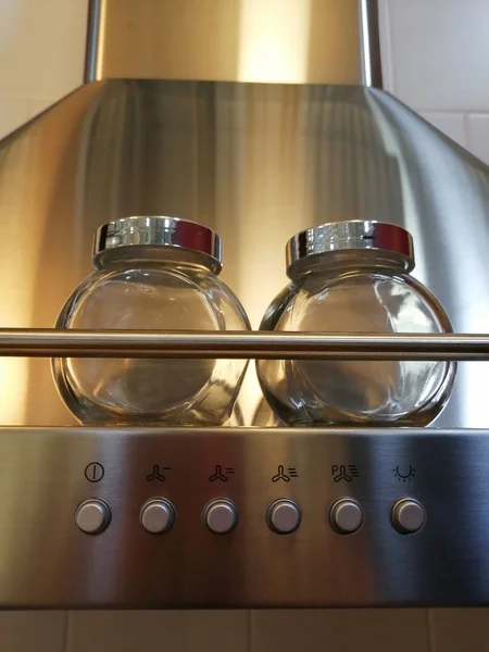 Hood for the kitchen. Silver. Two spice jars. Glass with iron lids