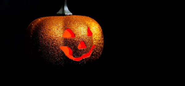 Good Halloween pumpkin on a black background. Free space for text. Red eyes.Side view. — Stock Photo, Image