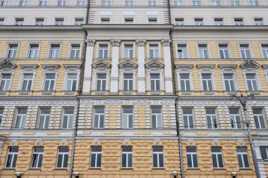 Eski binanın cephesinde üst üste birkaç Windows. Pencereler mermer duvarda üst üste. Yüksek bir binada Windows satırları.