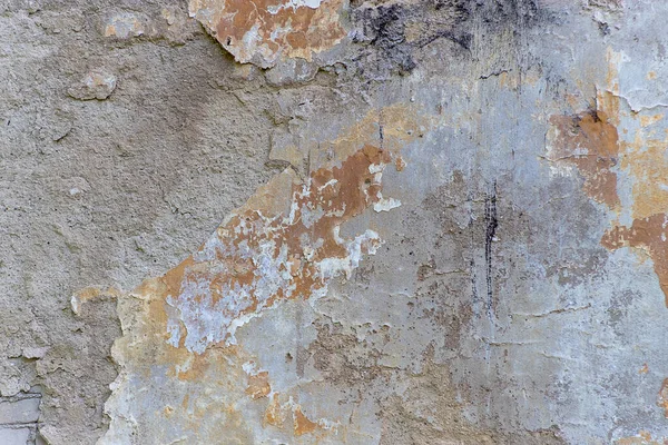 Grunge eski bir binanın beton duvarını yıktı. Doğal yok olmuş taş yüzeyi. Eski püskü, çatlak sıva. Kirli duvar, grunge dokusu. Boyanmış beton, soyut hasarlı mimari zemin.