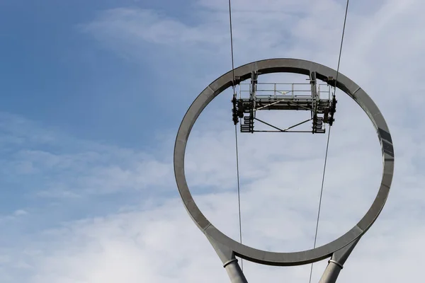 Cable car for sightseeing. Part of the design detail close-up against a blue sky with white clouds.