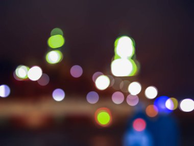 Odaklanamayan fotoğrafçılık. Noel 'de sokakta ışıklar ve bokeh. Soyut koyu bulanık şehir arkaplanı.