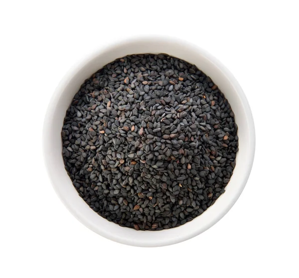 beyaz zemin üzerinde bir kasede susam