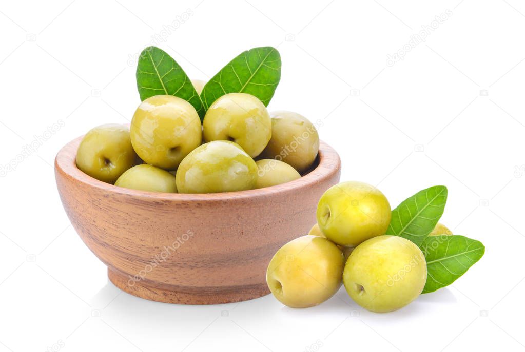 green olives in wood bowl on a white background