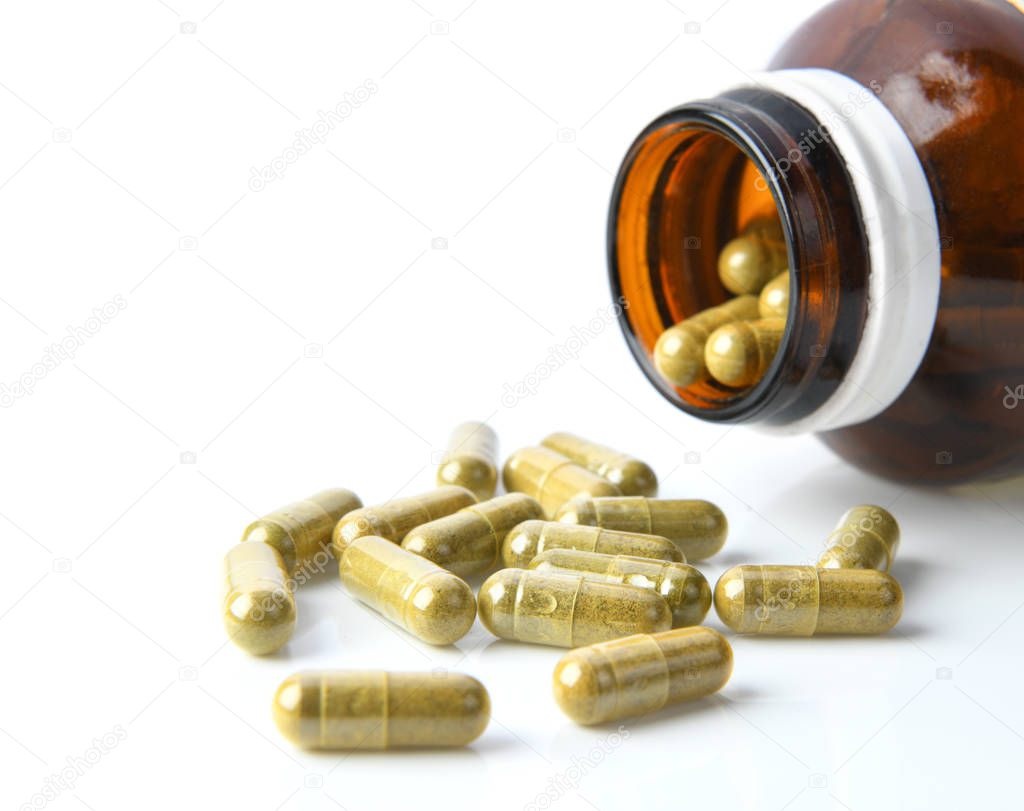 Herbal Capsules in bottle on white background