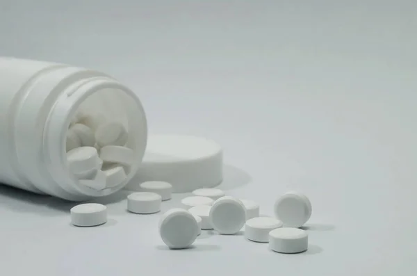 Aspirin parasetamol ilaç kapsülü antibiyotik için beyaz arka planda beyaz şişe tedavisine yardımcı olur