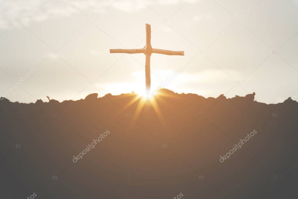 Cross crucifixion of jesus christ on a mountain silhouette with a sunset background. Easter concept day or Good friday