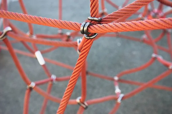Red ropes connected by reef metal knot — Stock Photo, Image