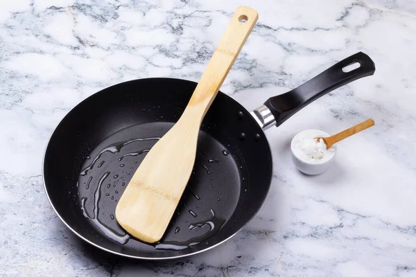 coconut oil with a spatula in a pan