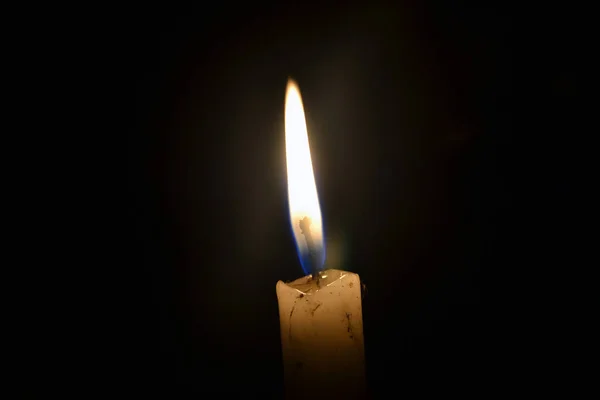 Single candle burning in the dark — Stock Photo, Image
