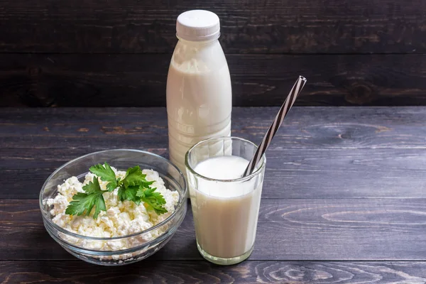 Fresh plain homemade yougurt and cottage cheese yogurt, youghurt, kefir, ayran, lassi in glass with herbs over wooden background, copy space Probiotic cold fermented dairy drink.