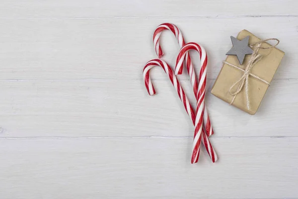 Christmas decorations with candy and gifts on white background