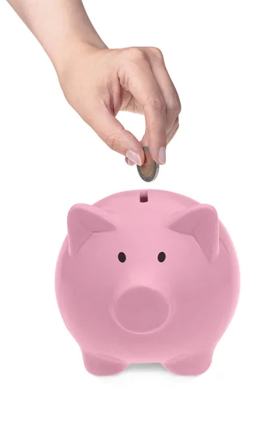 Hand putting coin into piggy bank — Stock Photo, Image