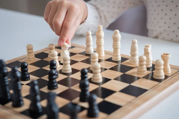 En flicka lära sig att spela schack spel — Stockfoto