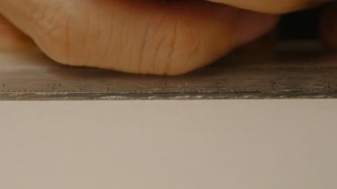 Yakın çekim erkek mimar eller cetvel ve kalem ile beyaz karton üzerinde işareti çizim. Model yapma süreci. 