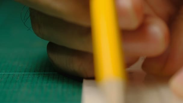 男建筑师手用尺子和黄色铅笔在白色纸板上画一条线的特写镜头 模型制作过程 — 图库视频影像
