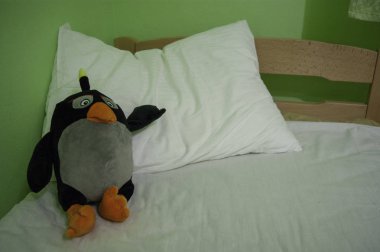 Good night - soft toy penguin on a pillow clipart