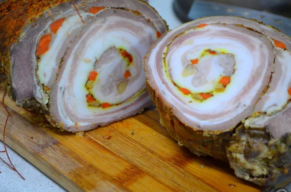Meatloaf with bacon and carrot rolled in a mixture of spices