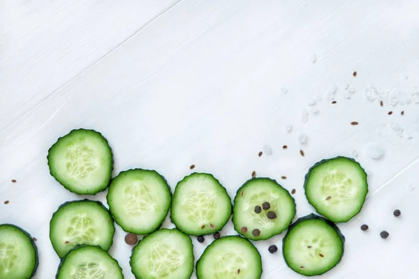 Flat lay composition of chopped green cucumbers. Top view, copy space for text. — Stock Photo, Image