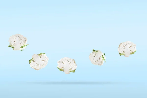 Freshly Cut Half Cauliflower Five Pieces Soaring Blue Background Vegetables — Zdjęcie stockowe