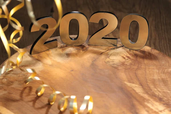 Happy New Year 2020. Symbol from number 2020 on wooden background