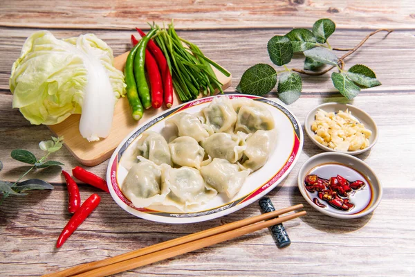 Boiled dumpling is Chinese dumplings or potstickers in boiling water. Dumpling is a dough and wrapped around a filling.