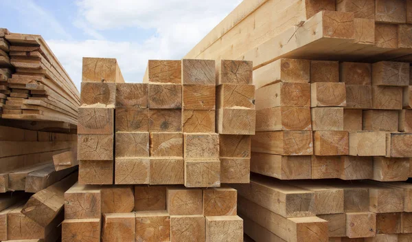 Lumber warehouse. Wood planks and timber stacked in stacks outdo