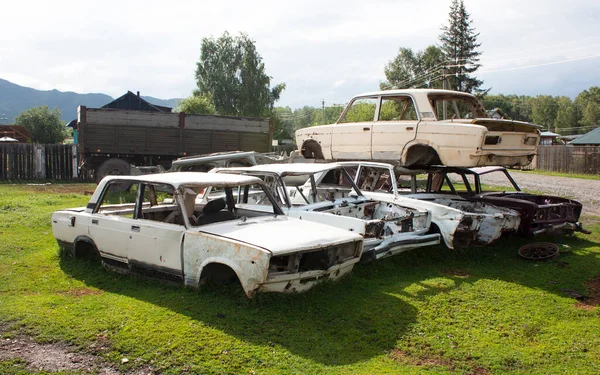Car cemetery. Old broken cases of Russian cars lie on the ground