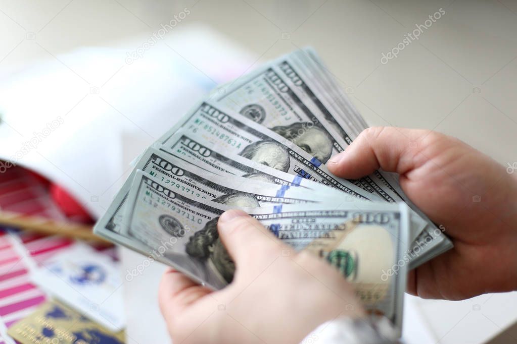 Male hands counting money from huge pack