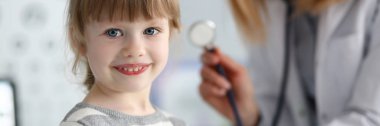 Gülümseyen sevimli küçük hasta kadın doktor ile etkileşim