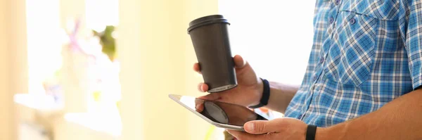 Millennial man Hold Tablet med kaffekopp — Stockfoto