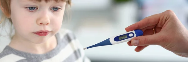 Female arm hold electronic thermometer showing high temperature and bottle of tablets — Stock Photo, Image