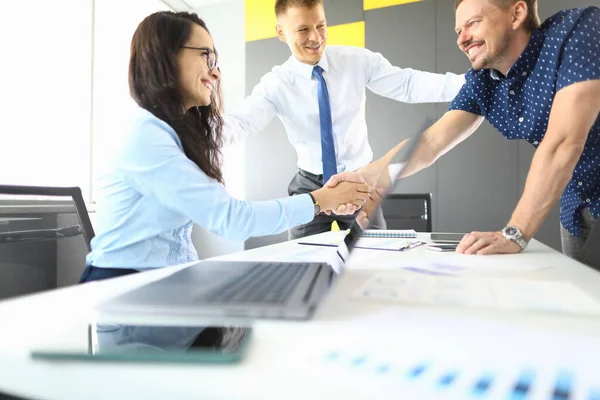 Empresários e empresárias em seu escritório sorrindo e apertando as mãos — Fotografia de Stock