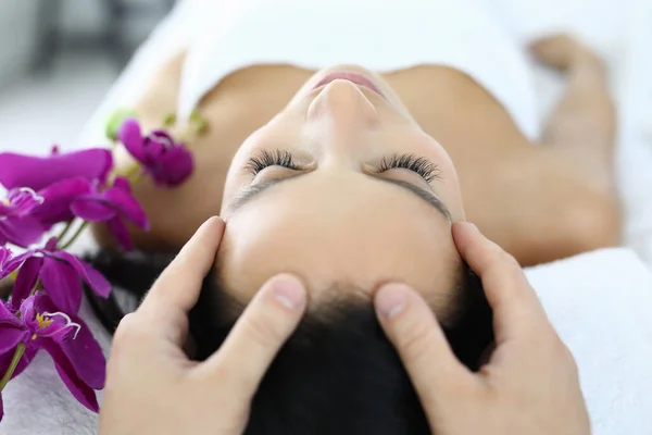 Woman is given facial massage at spa closeup — Stock Photo, Image