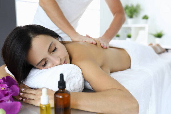 Woman is given massage to relieve tension and stress.