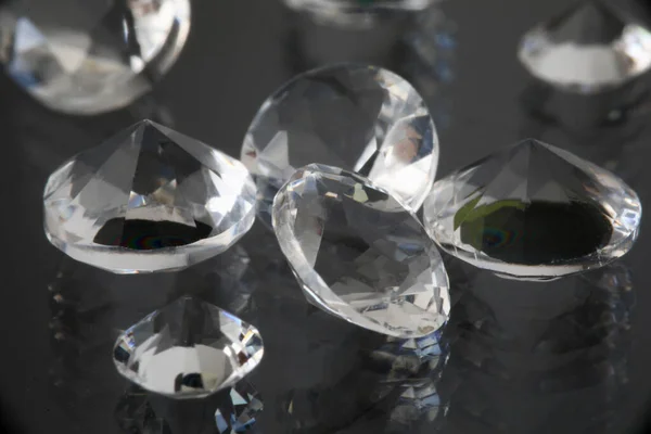 Precious expensive stones lie on black background — Stock Photo, Image