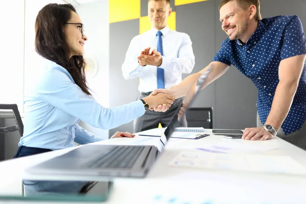 Man and woman businessmen shake hands at table with laptop in office portrait — Stock Photo, Image
