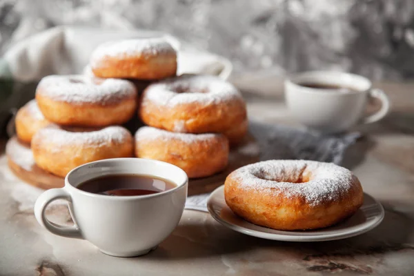 Donuts sprinkled with powdered sugar — Stock Photo, Image