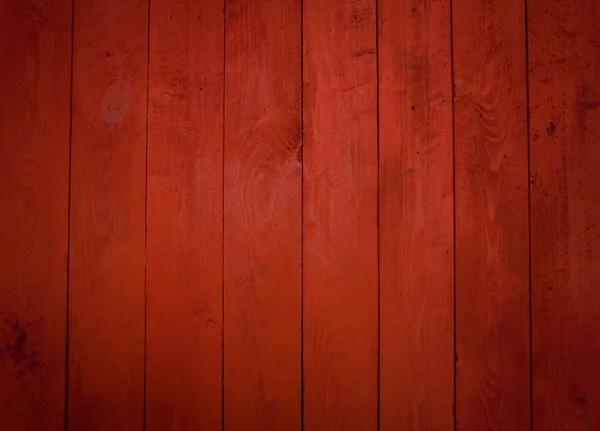 Red wall of boards. The texture of the wooden fence.