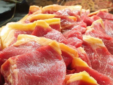 Restoranda arka plan olarak dilimlenmiş çiğ sığır eti, ızgara veya yemek pişirmek için taze et üst görünümü