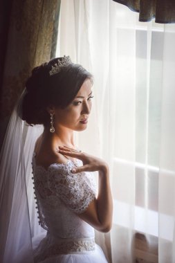 beautiful bride with a bouquet of white roses