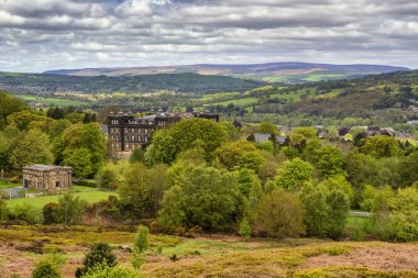 Walking on the Dales High Way between Ilkley and Addingham in West Yorkshire, showing the Swastika Stone and Ilkley Moor.  clipart